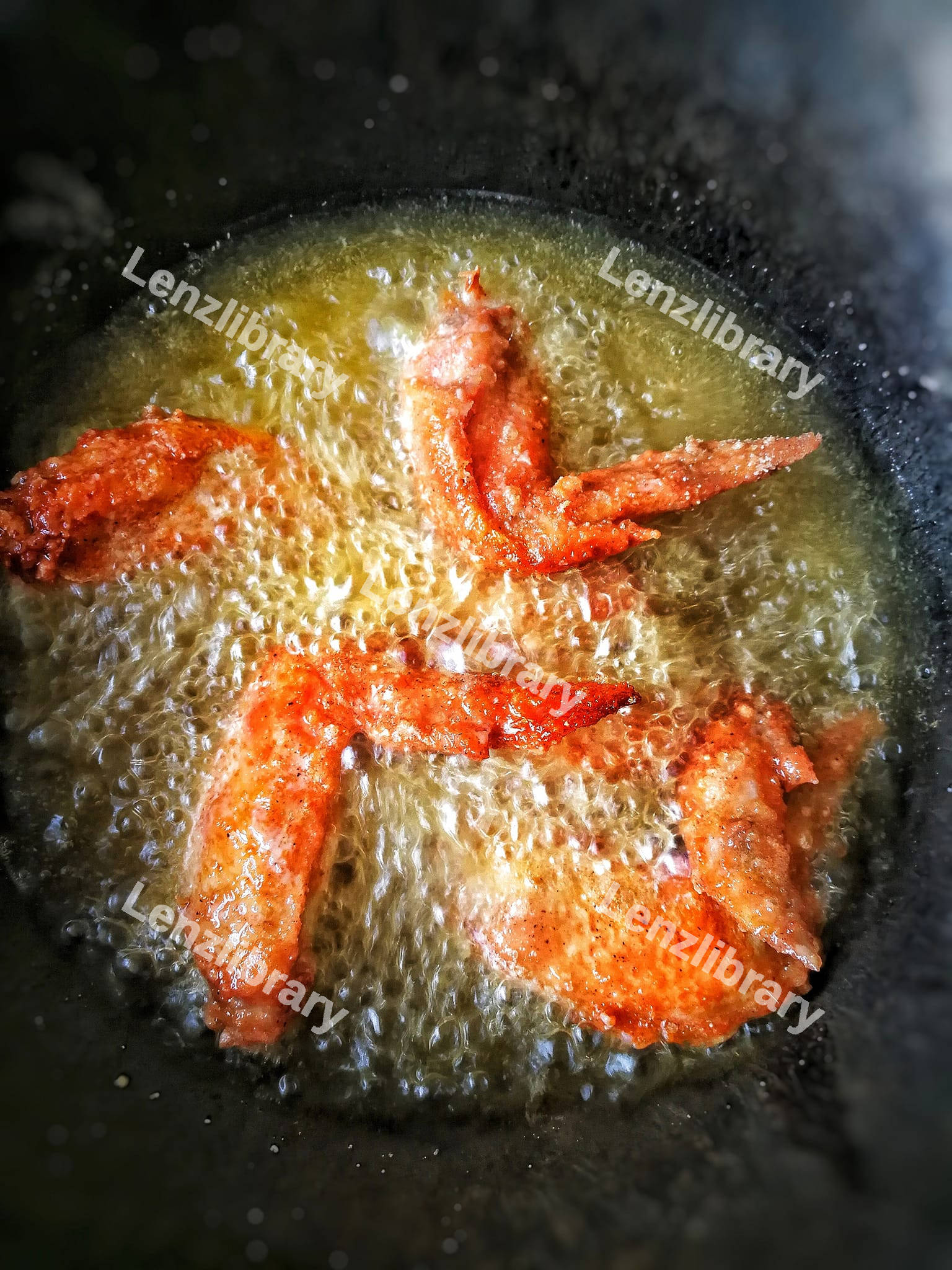 Fried chicken wings in the boiling oil